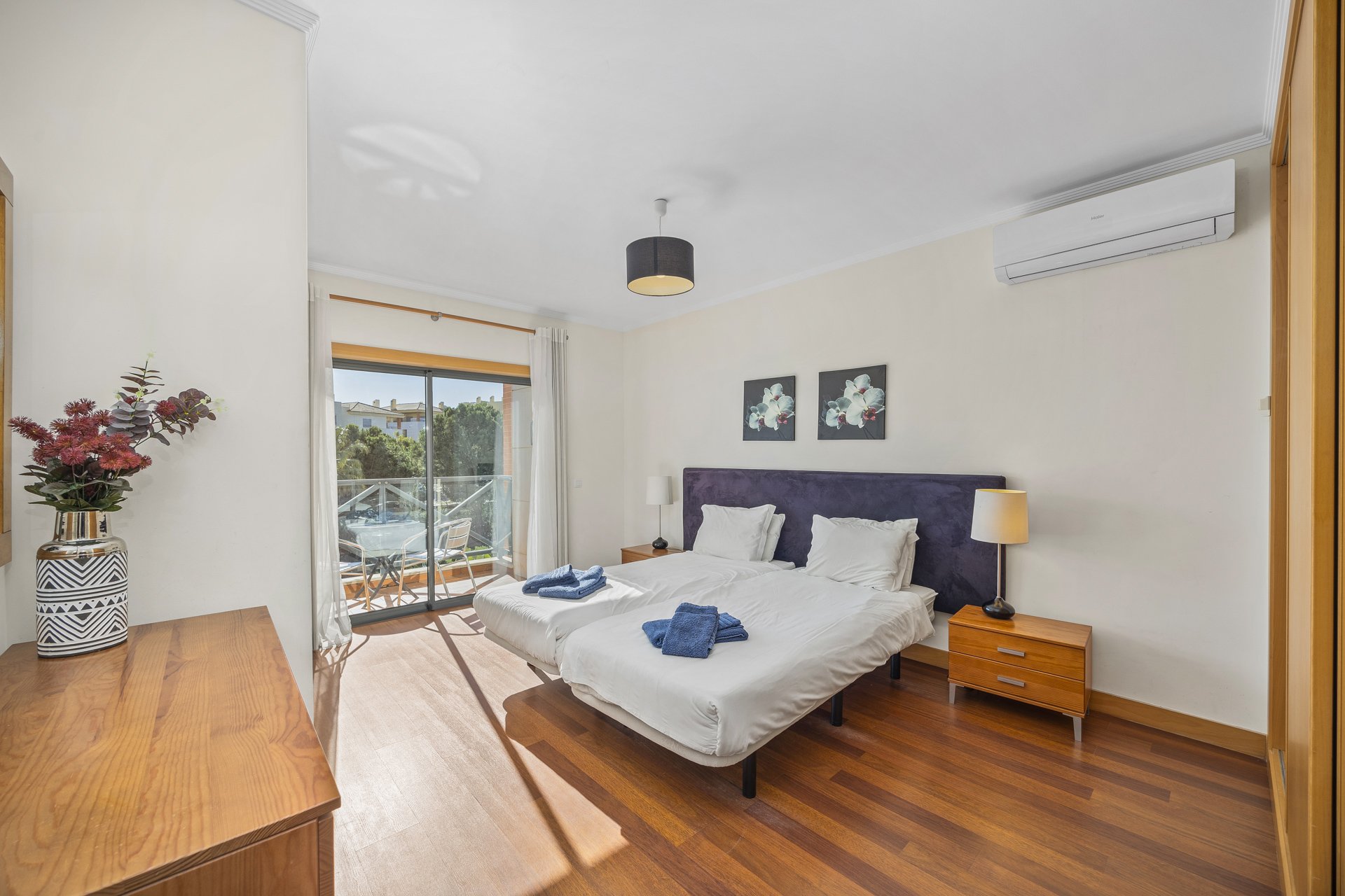Bedroom with dresser and balcony window