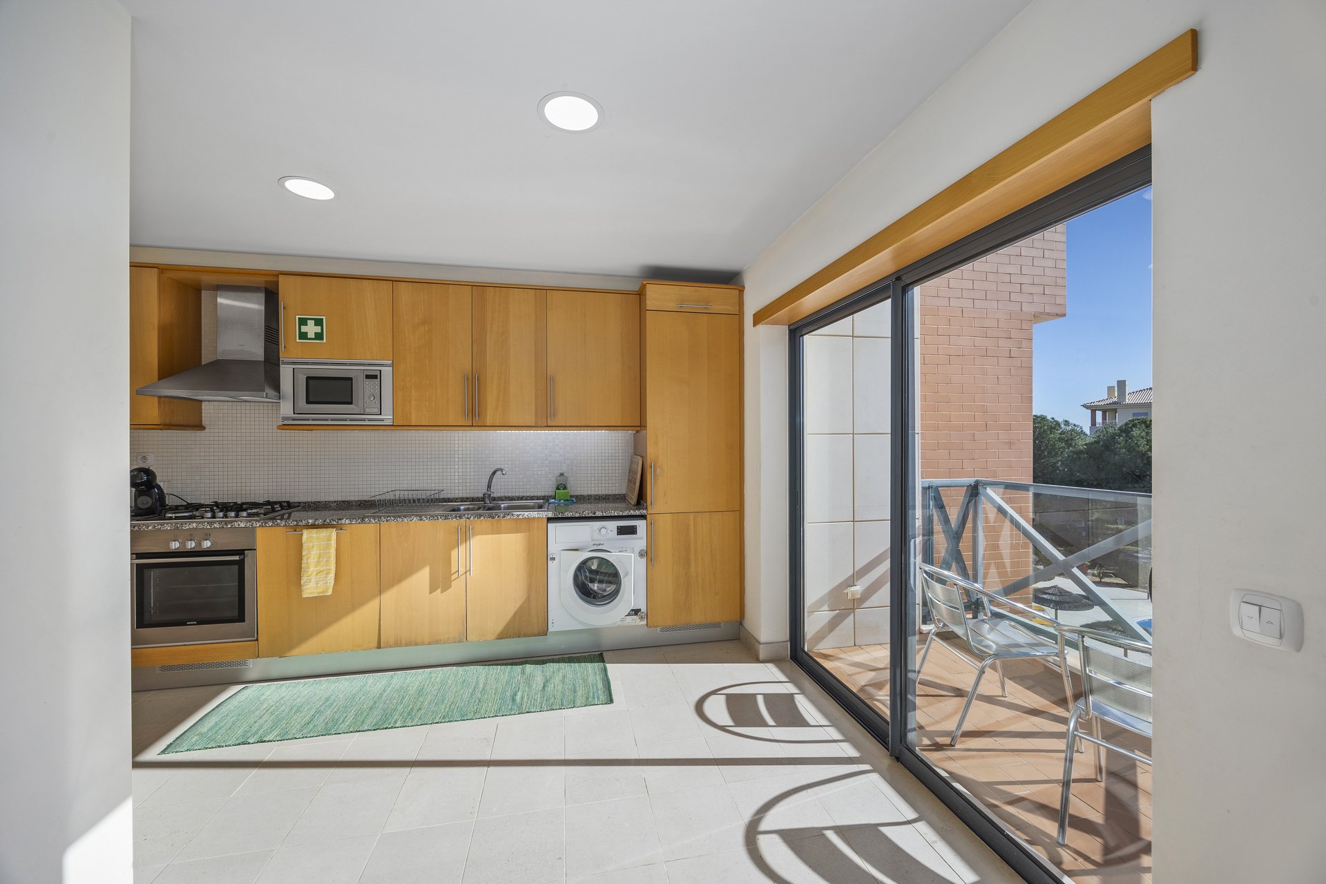 Kitchen with sliding door to private balcony