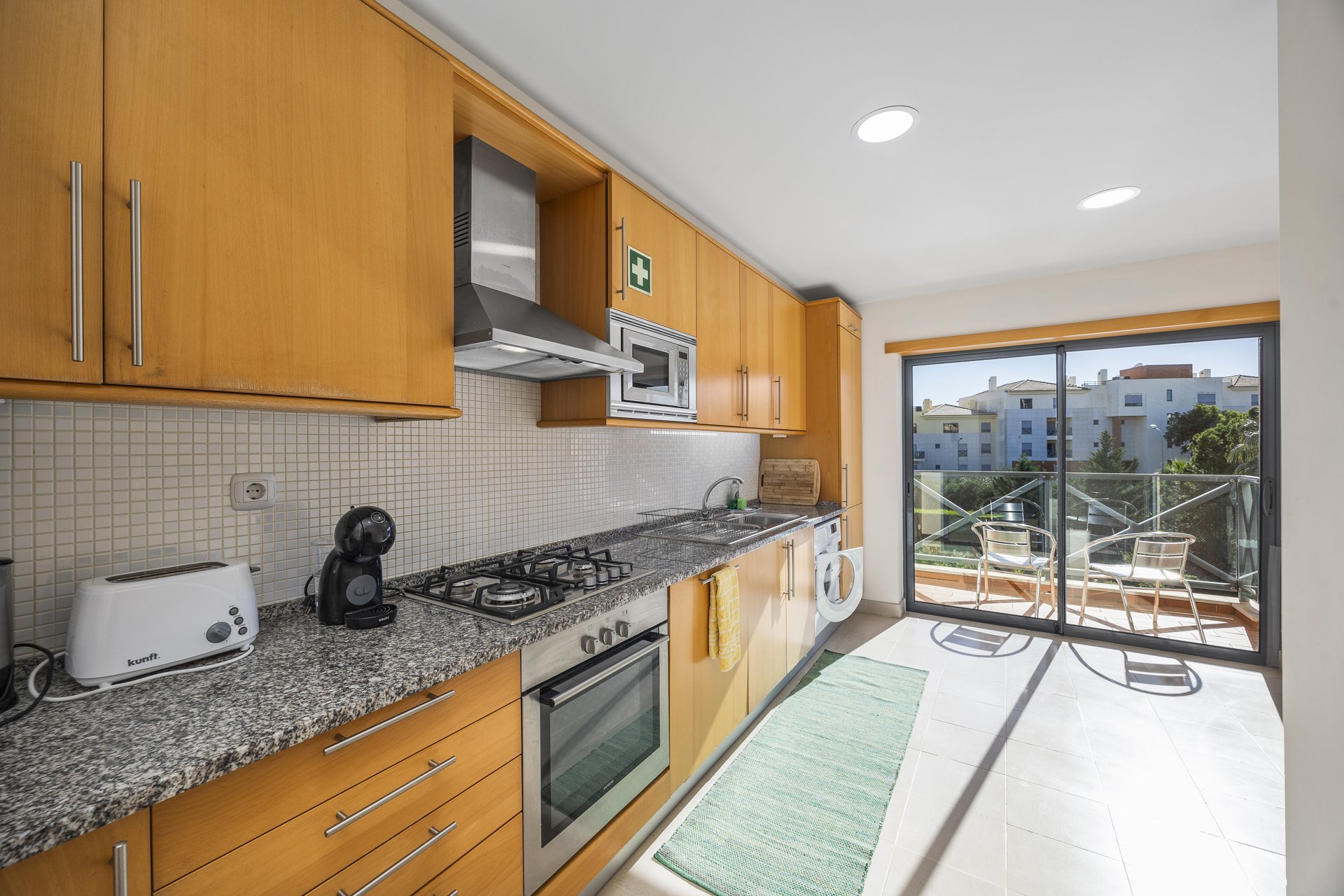 Kitchen hob with balcony seating beyond
