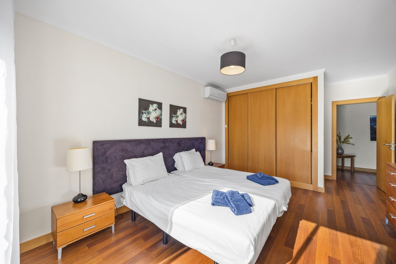 Bedroom with wardrobe and hallway access