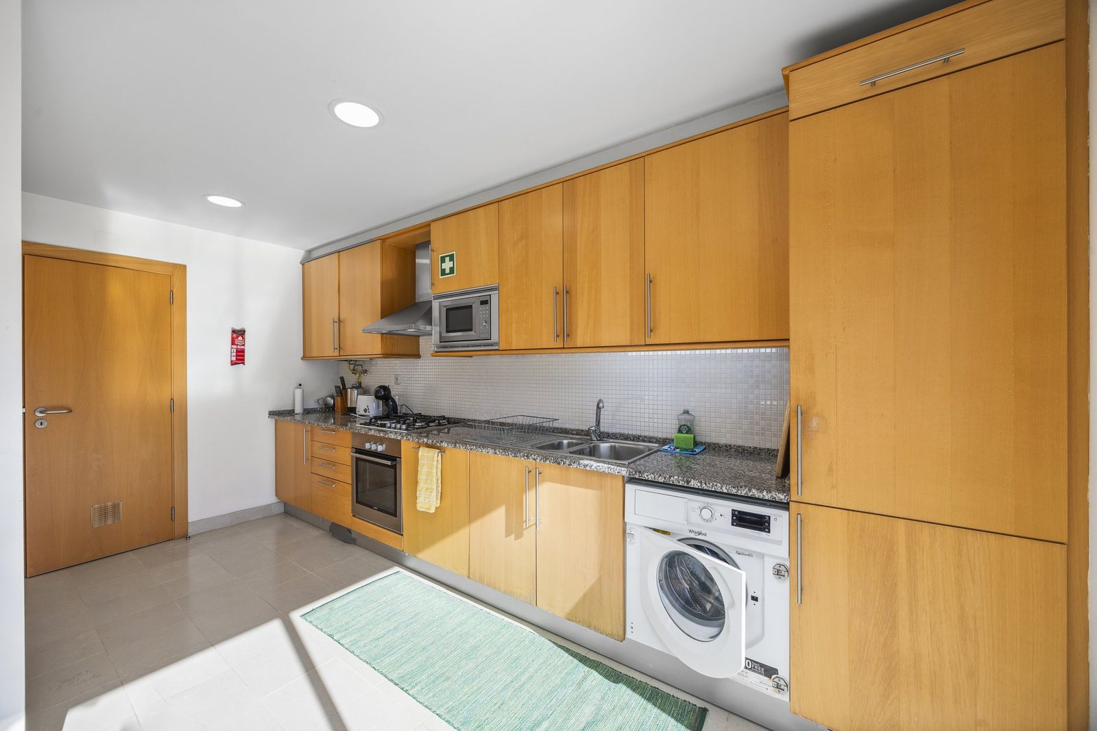 Kitchen with granite countertops and integrated appliances