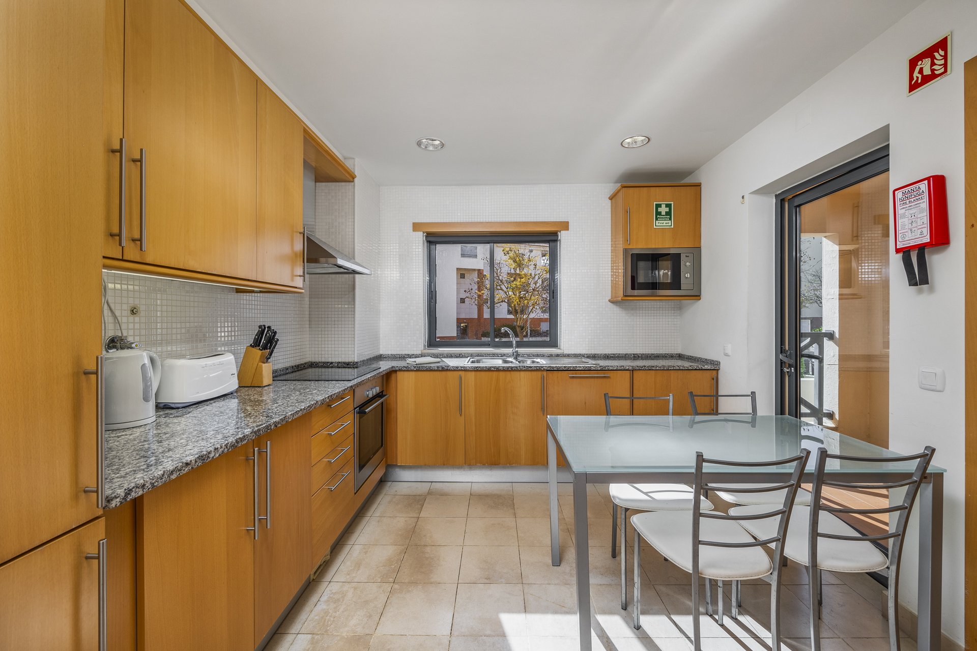 Kitchen with dining table and balcony access