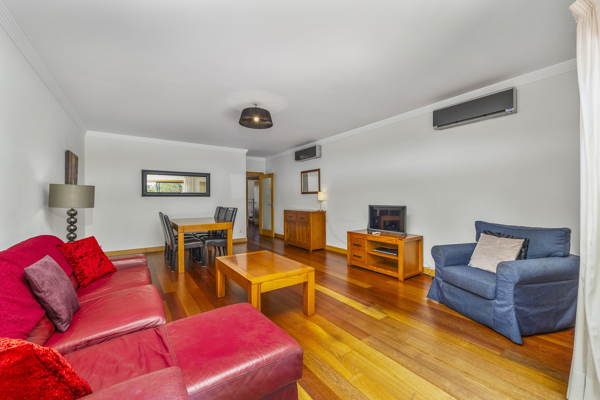 Living room with sofa, dining table, and TV
