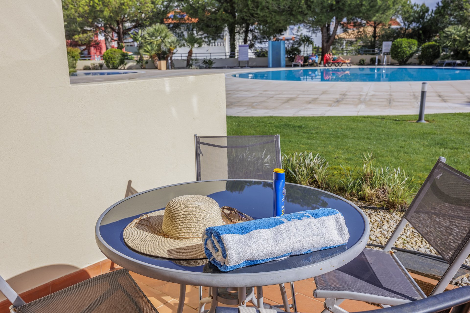 Terrace table with beach essentials and pool view