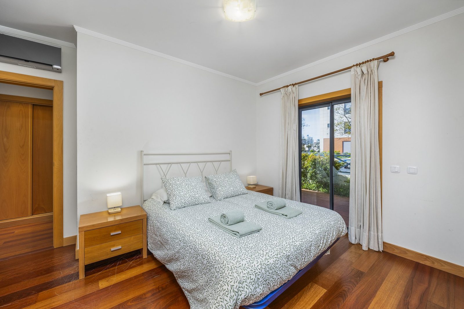 Master bedroom with double bed and balcony access