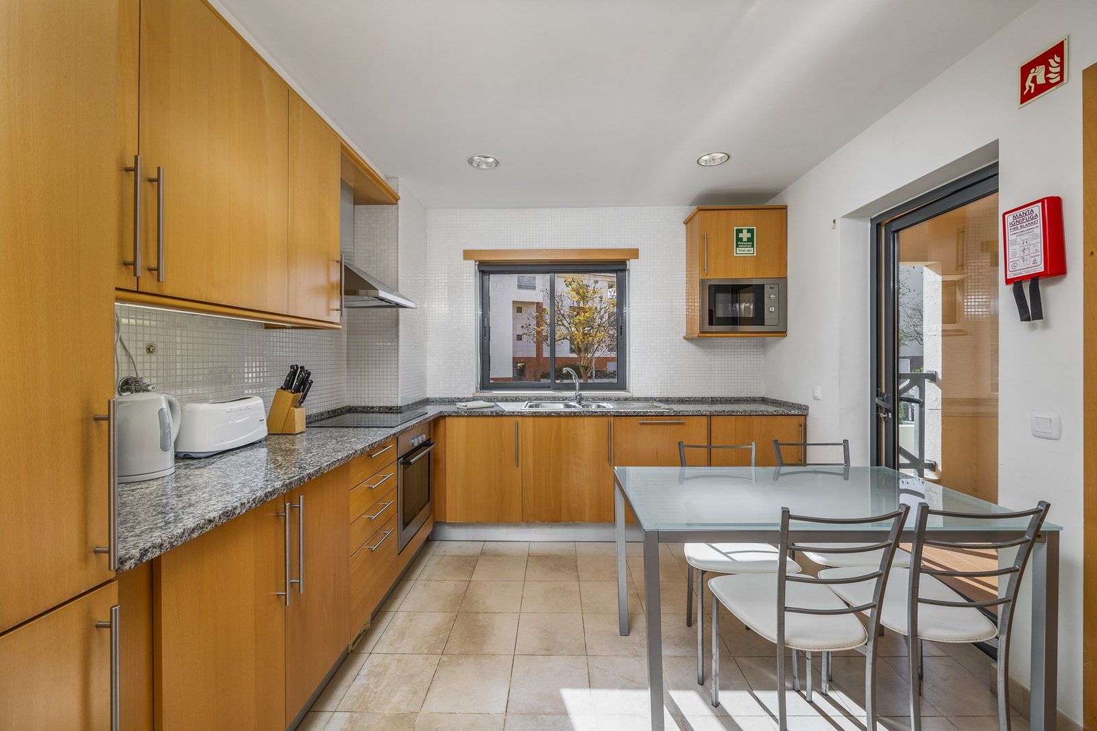 Kitchen with dining table and balcony access