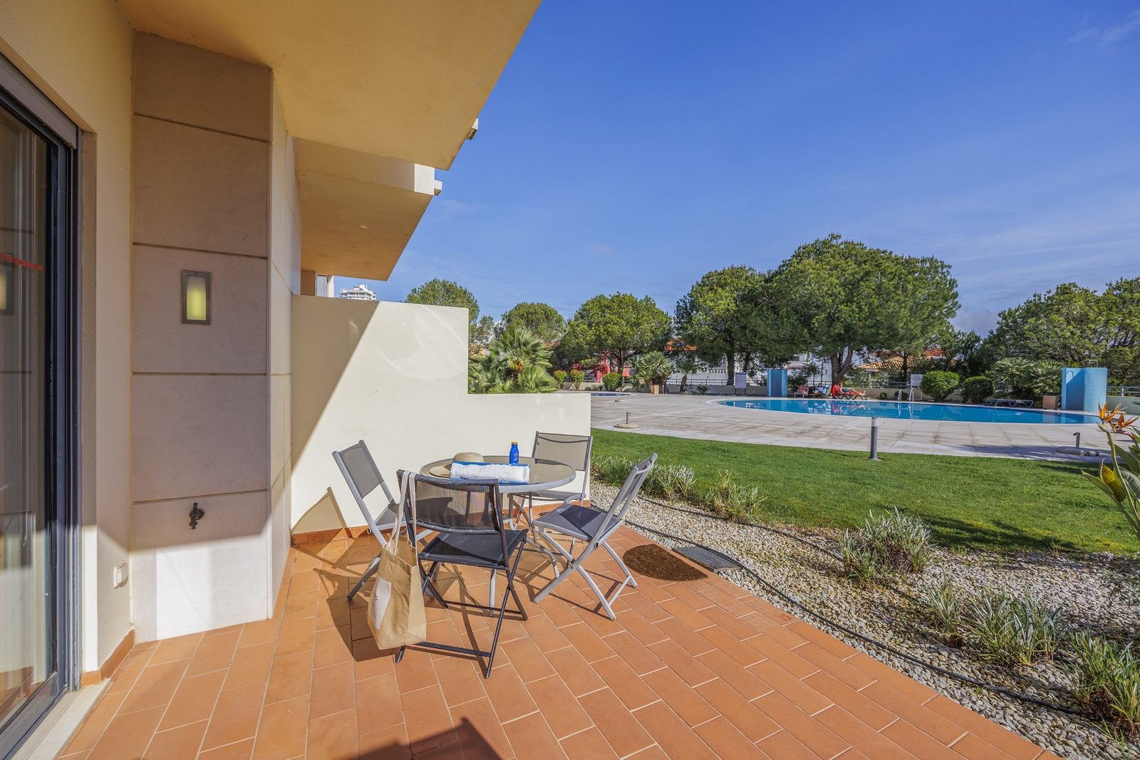 Terrace seating area with a view over the pool