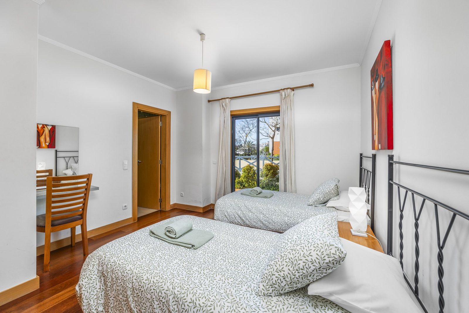Twin bedroom with two single beds and balcony access
