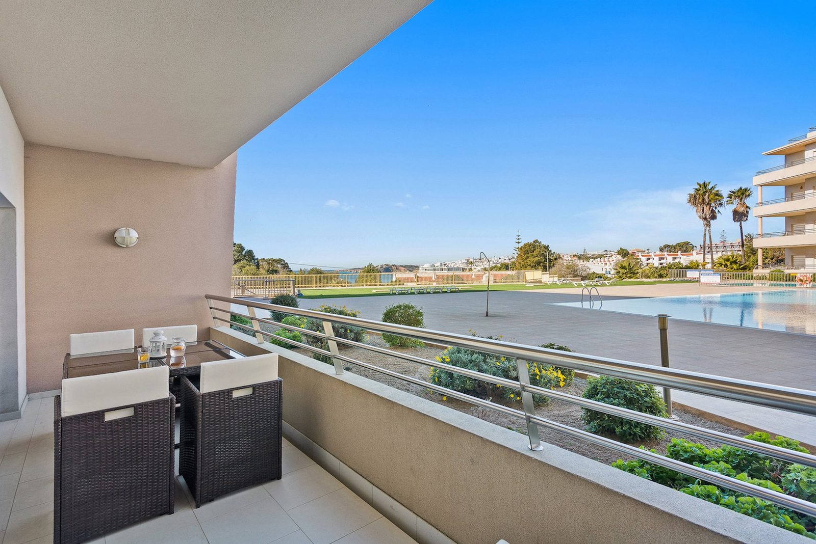 Balcony dining table with pool and sea view