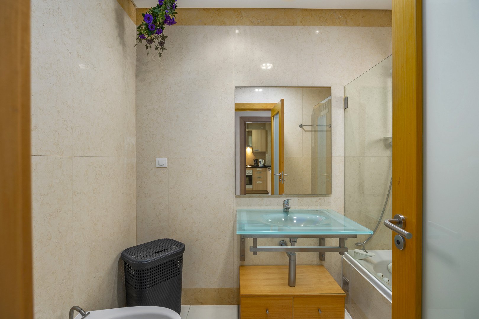 Bathroom with glass sink and bathtub