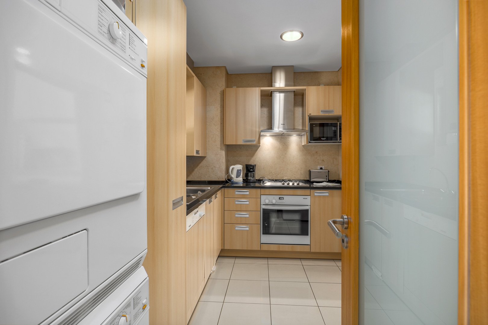 Kitchen with stacked washer and dryer