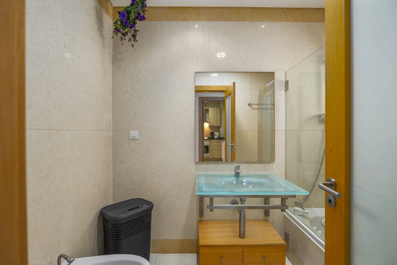 Bathroom with glass sink and bathtub