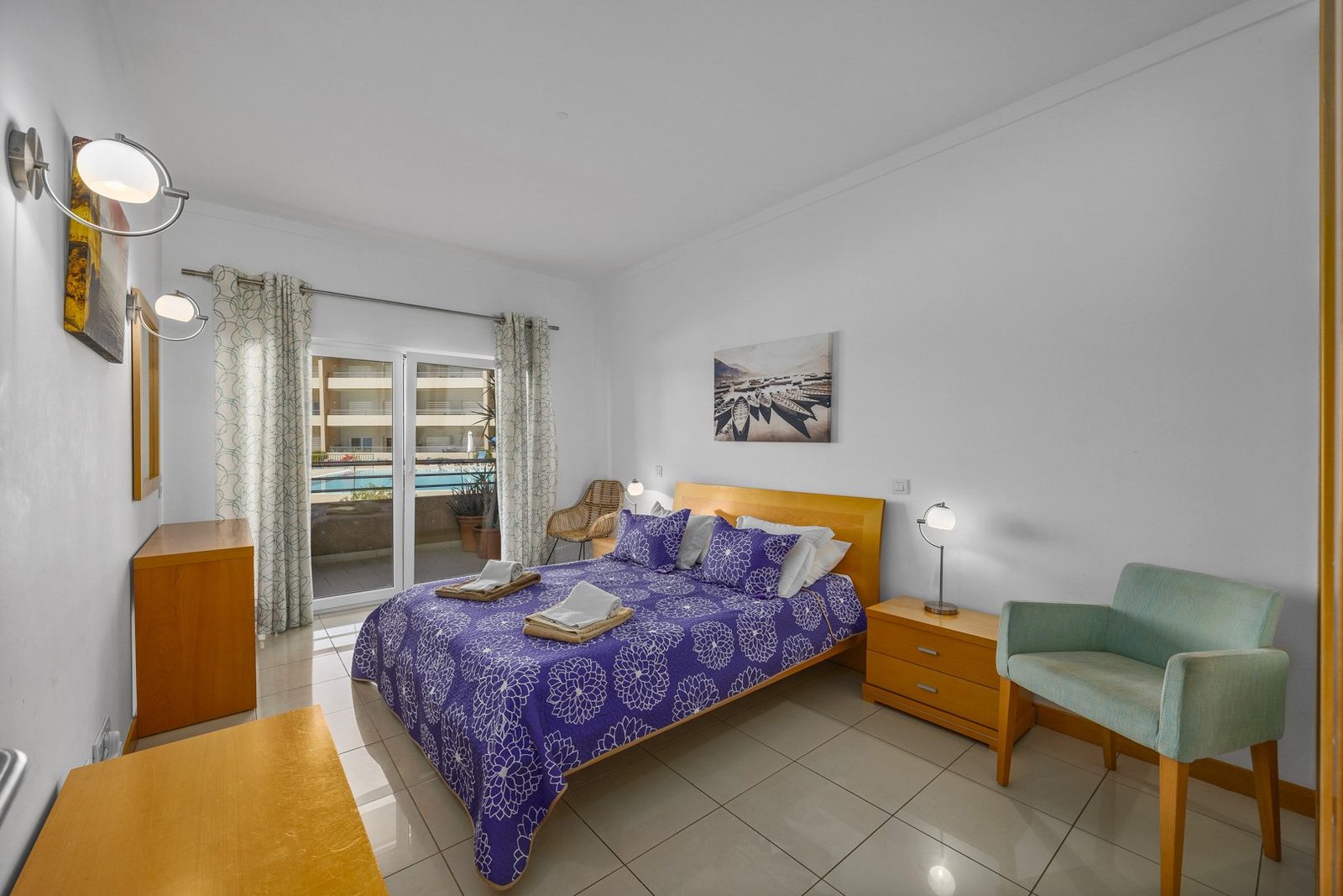Bedroom with pool view balcony access