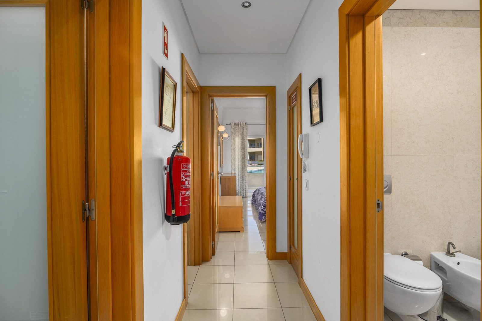 Hallway with access to bedrooms and bathroom