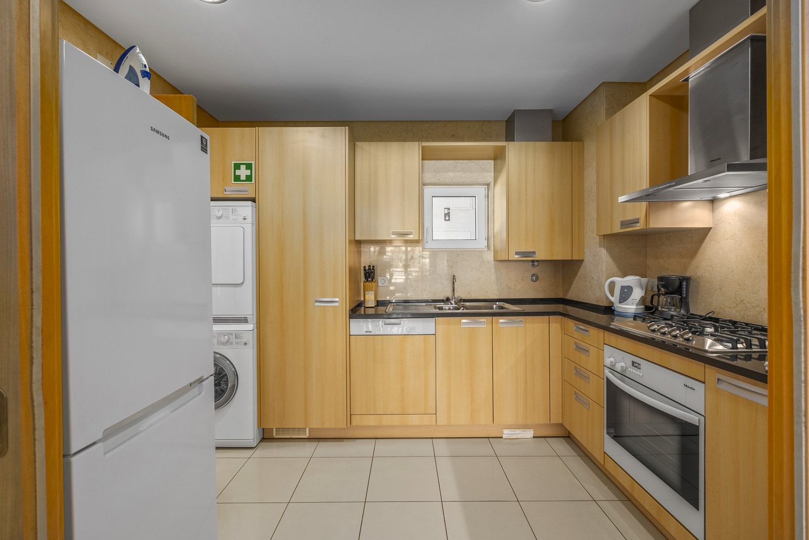 Kitchen with fridge, oven, and dining area access