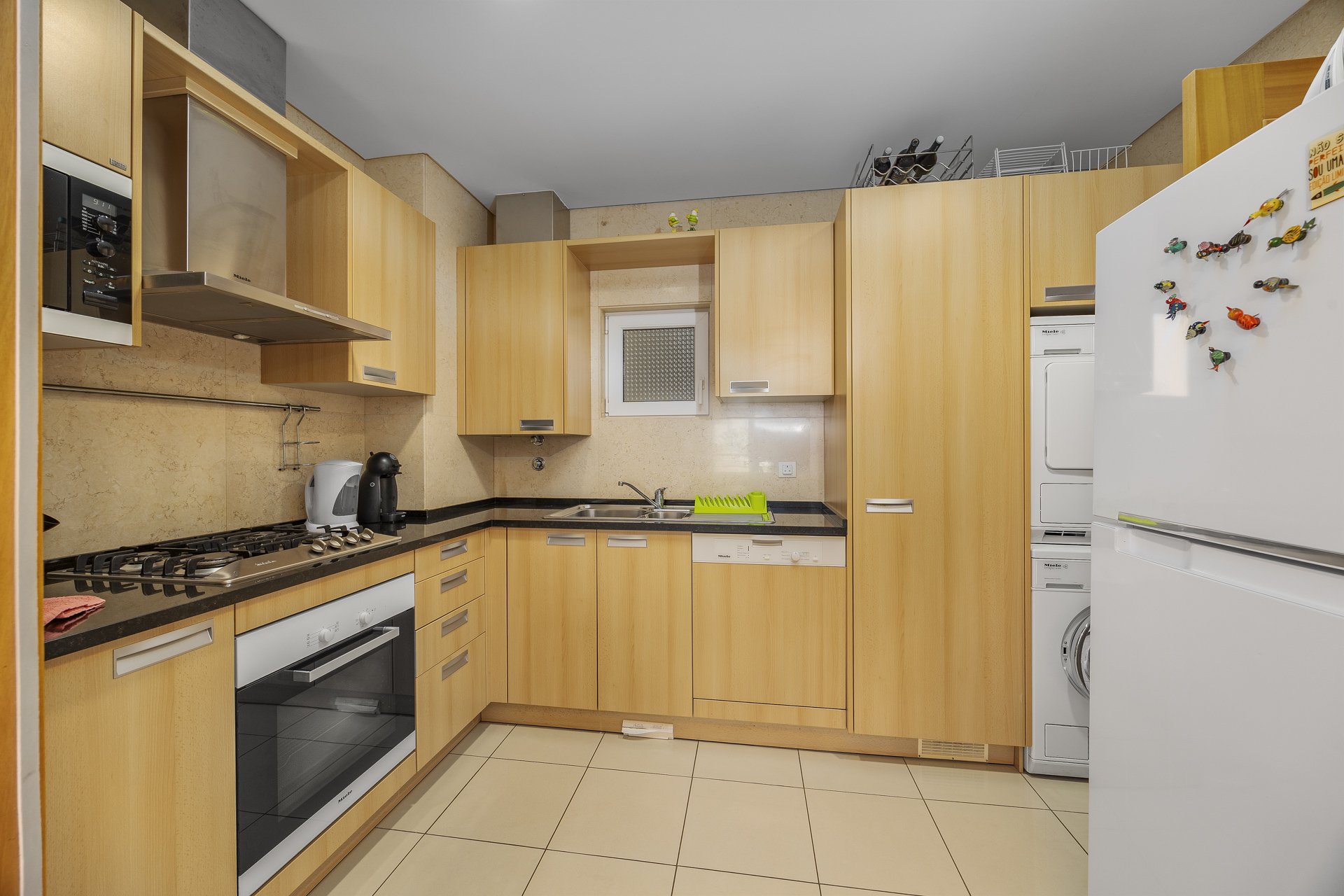 Full view of the kitchen with appliances and cabinetry