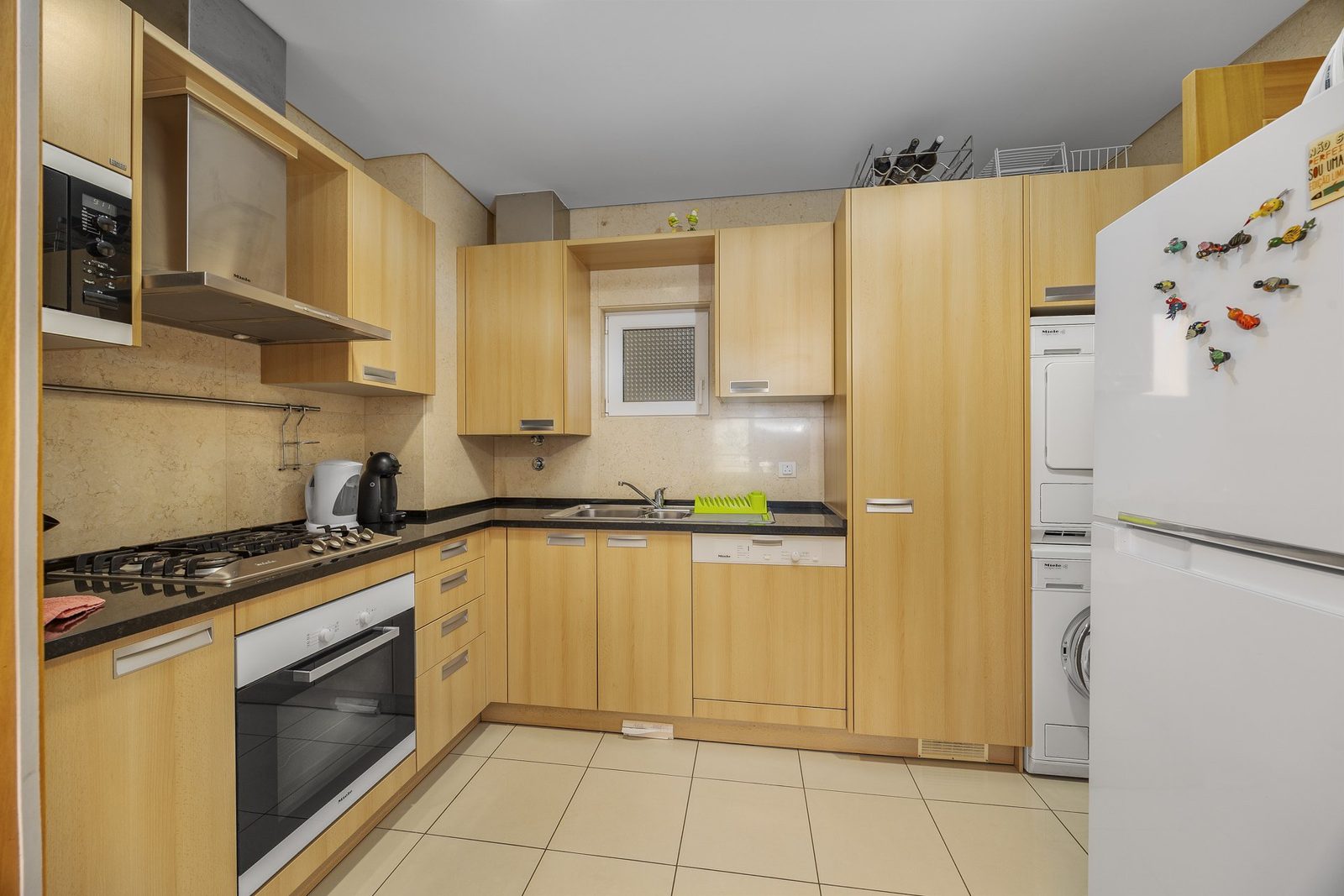 Full view of the kitchen with appliances and cabinetry