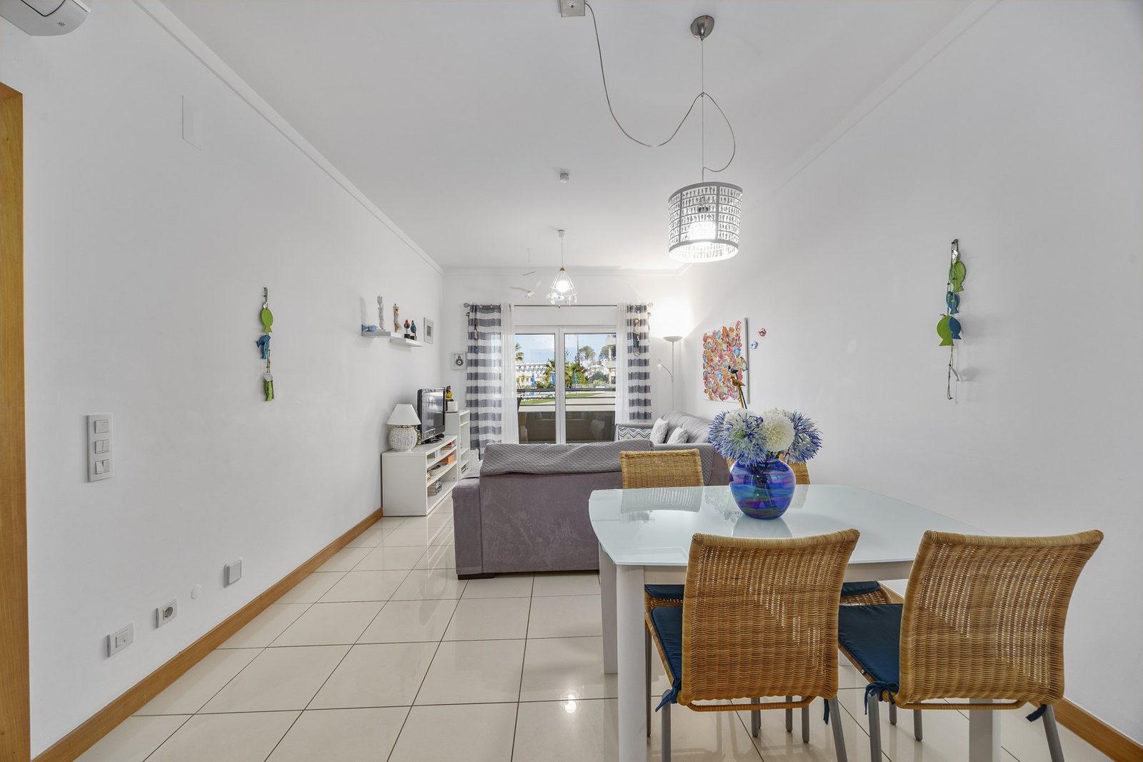 Dining table with sofa and balcony access