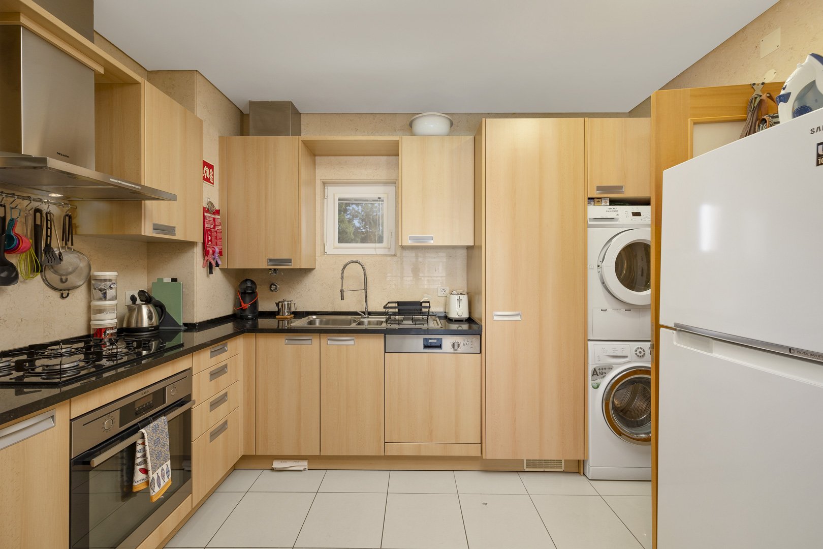 Kitchen with fridge, washer-dryer, and worktop