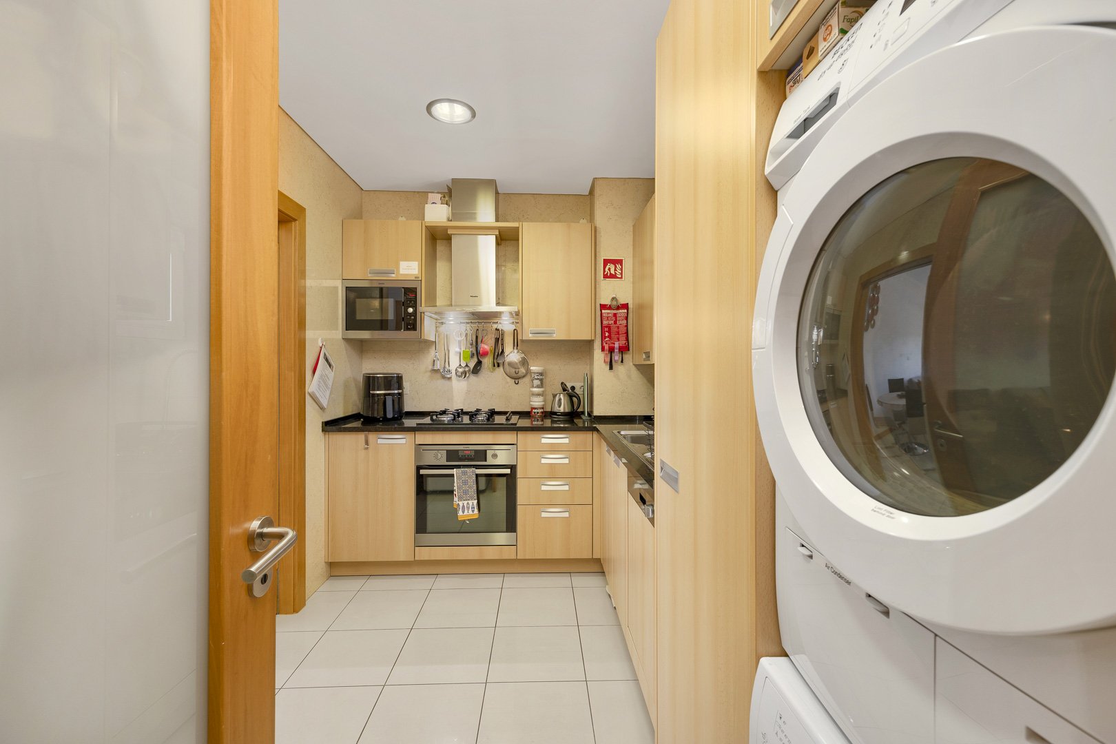Kitchen with washer-dryer and cabinetry