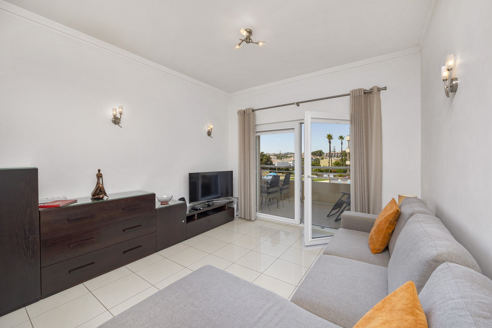 Living room with sofa and pool view balcony