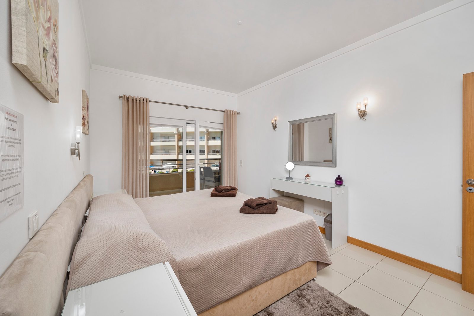 Bedroom with double bed, dressing table and balcony access