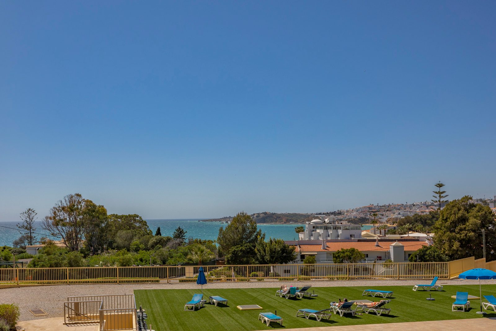 Communal gardens and sun loungers with a view of the sea