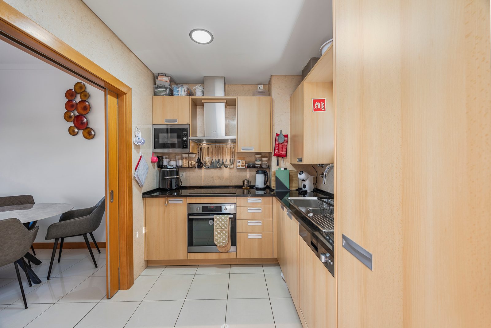 Kitchen with oven, microwave and sliding door to the dining area