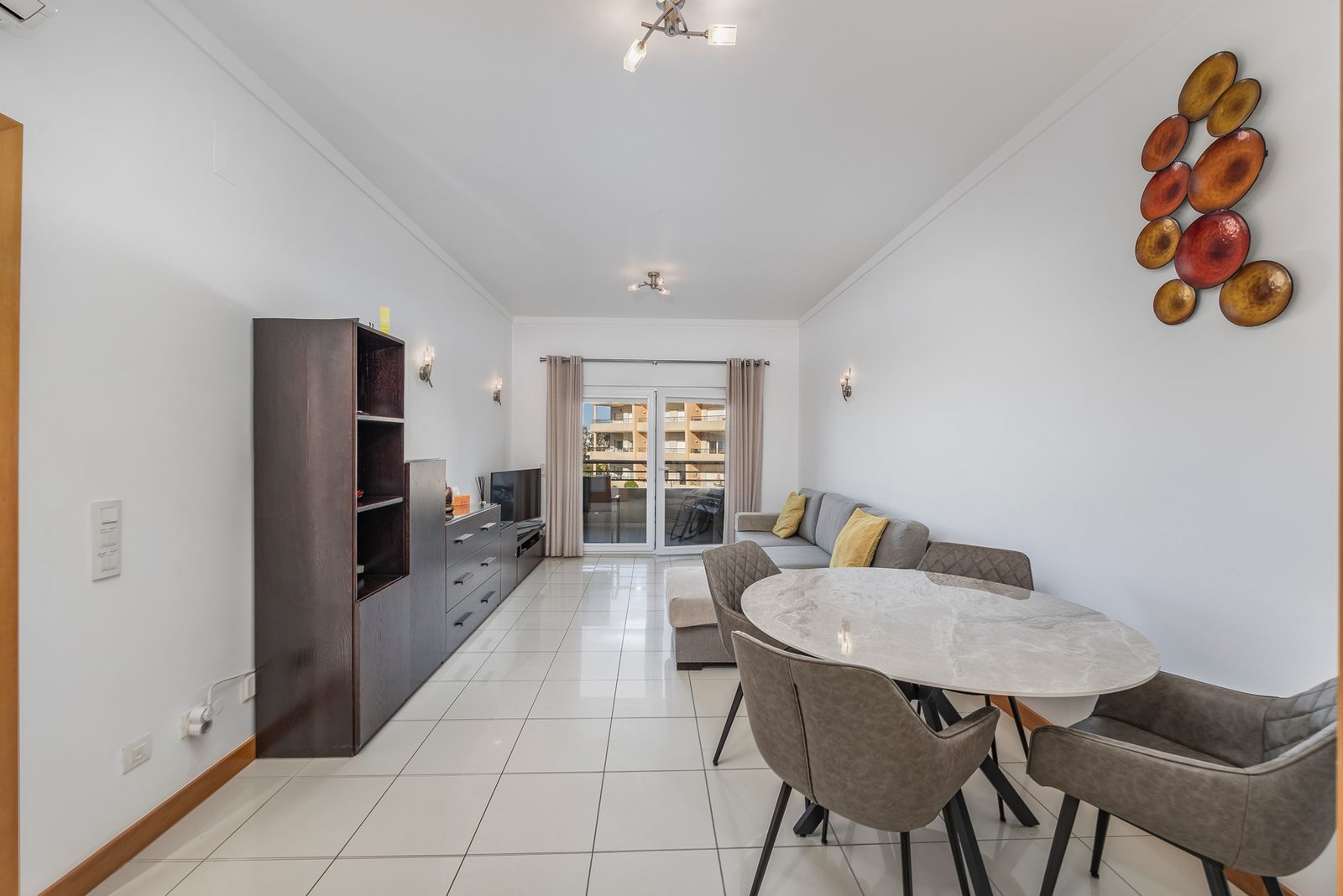 Open-plan living and dining room with TV and dining table