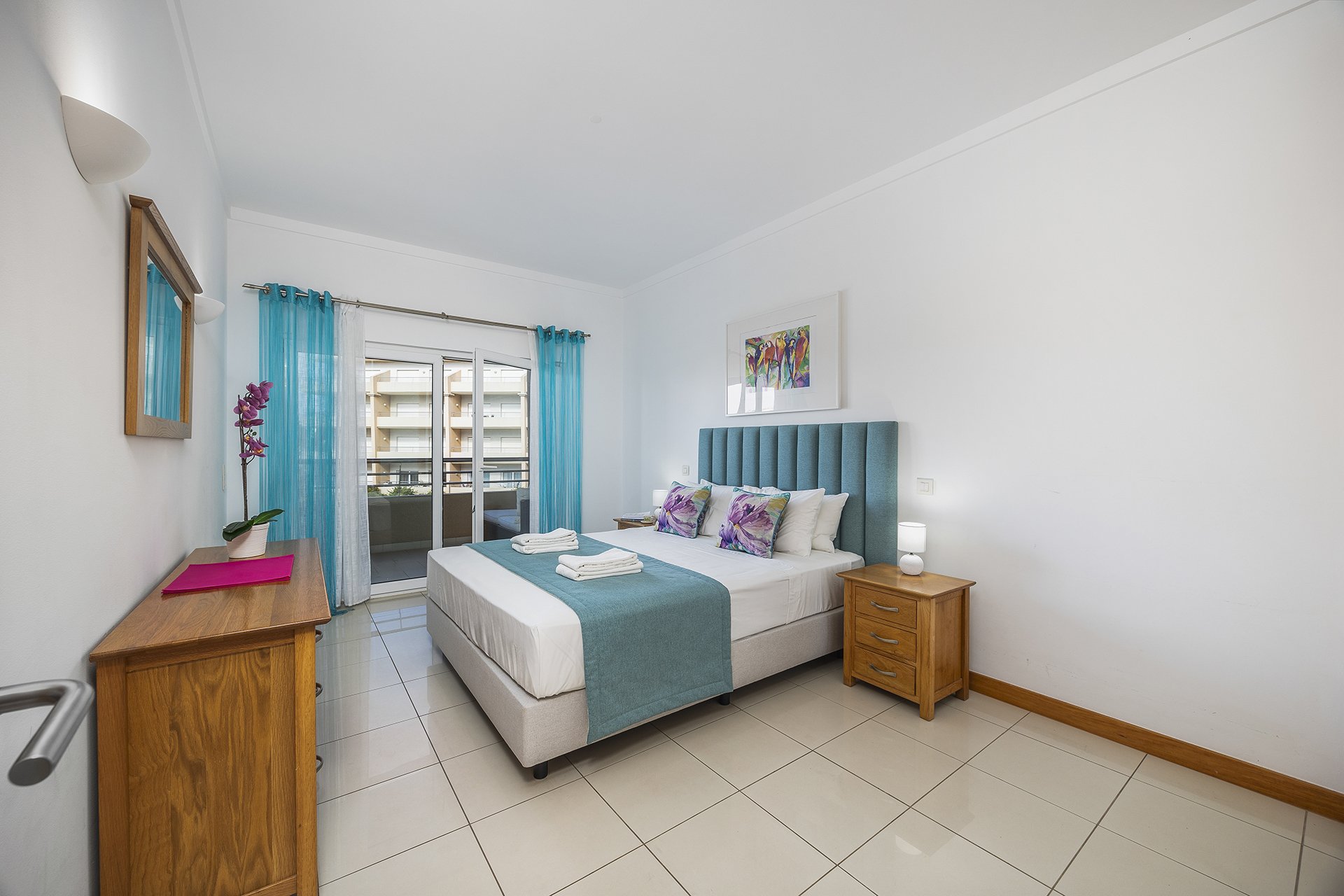 Bedroom with dresser and balcony door