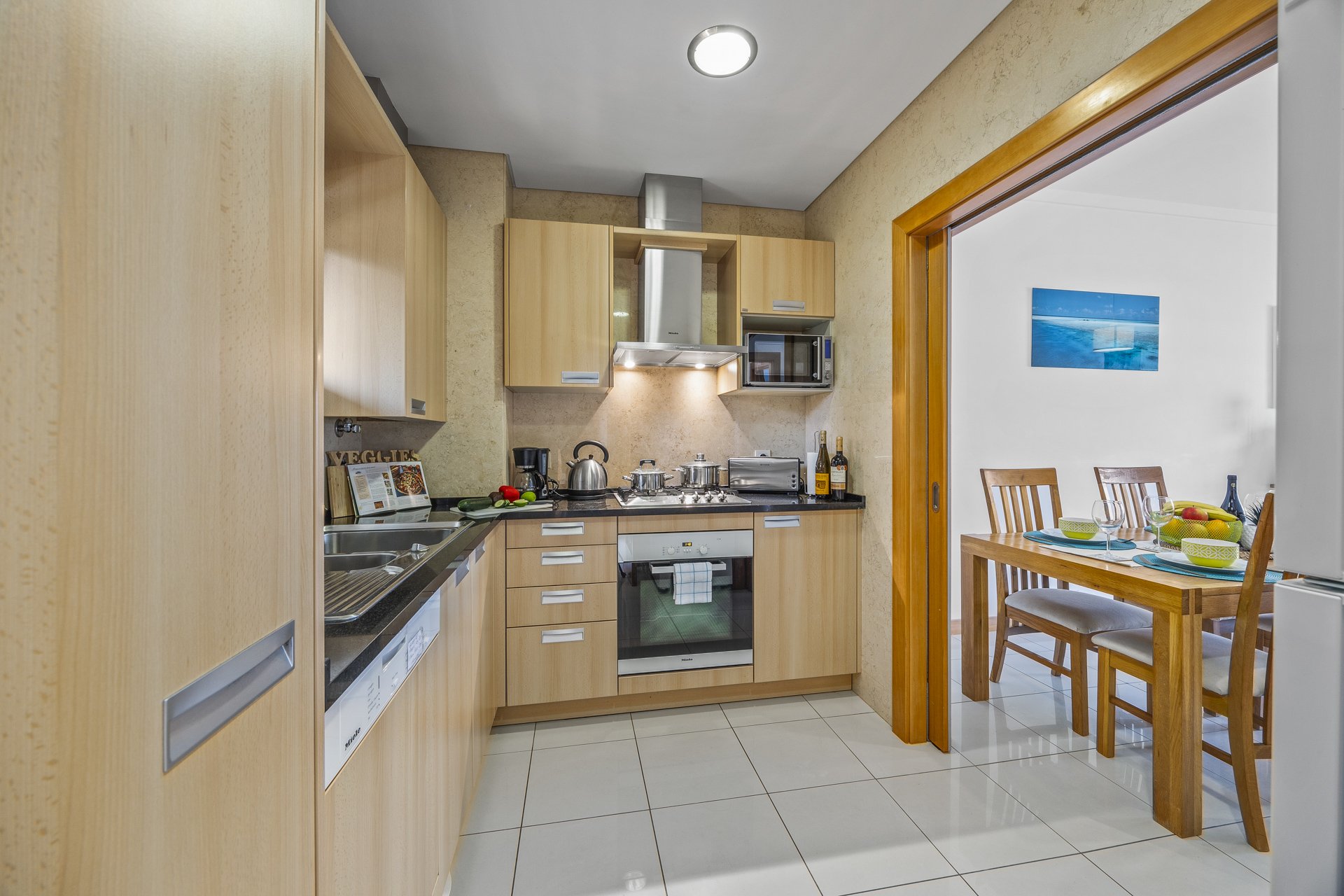 Kitchen with oven, hob, and sink