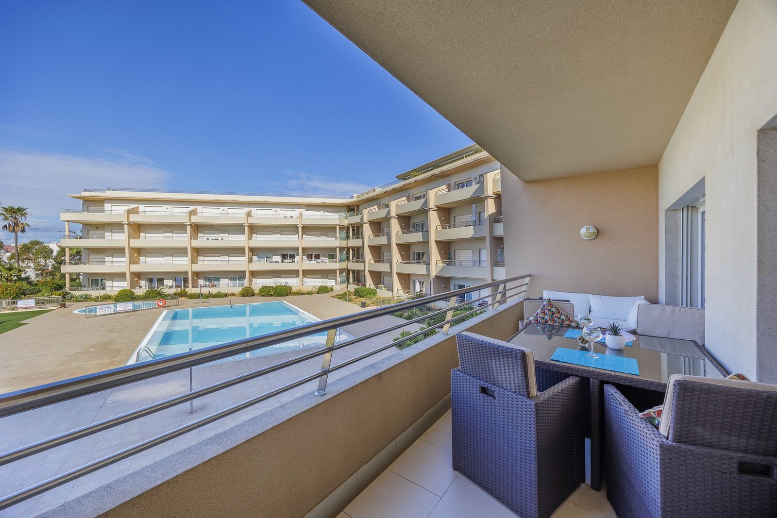 Balcony seating area overlooking the pool