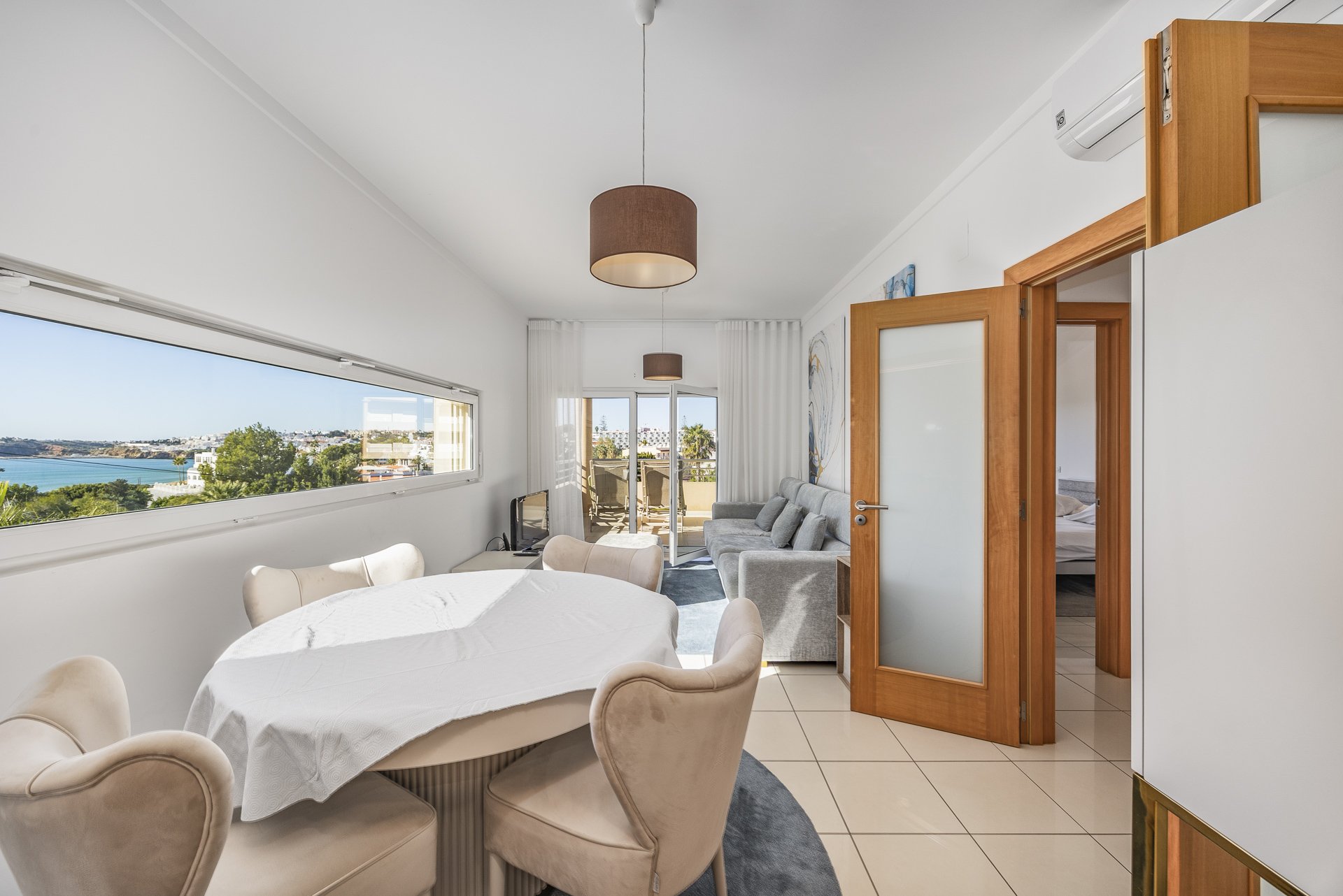 Living and dining area with panoramic sea view window