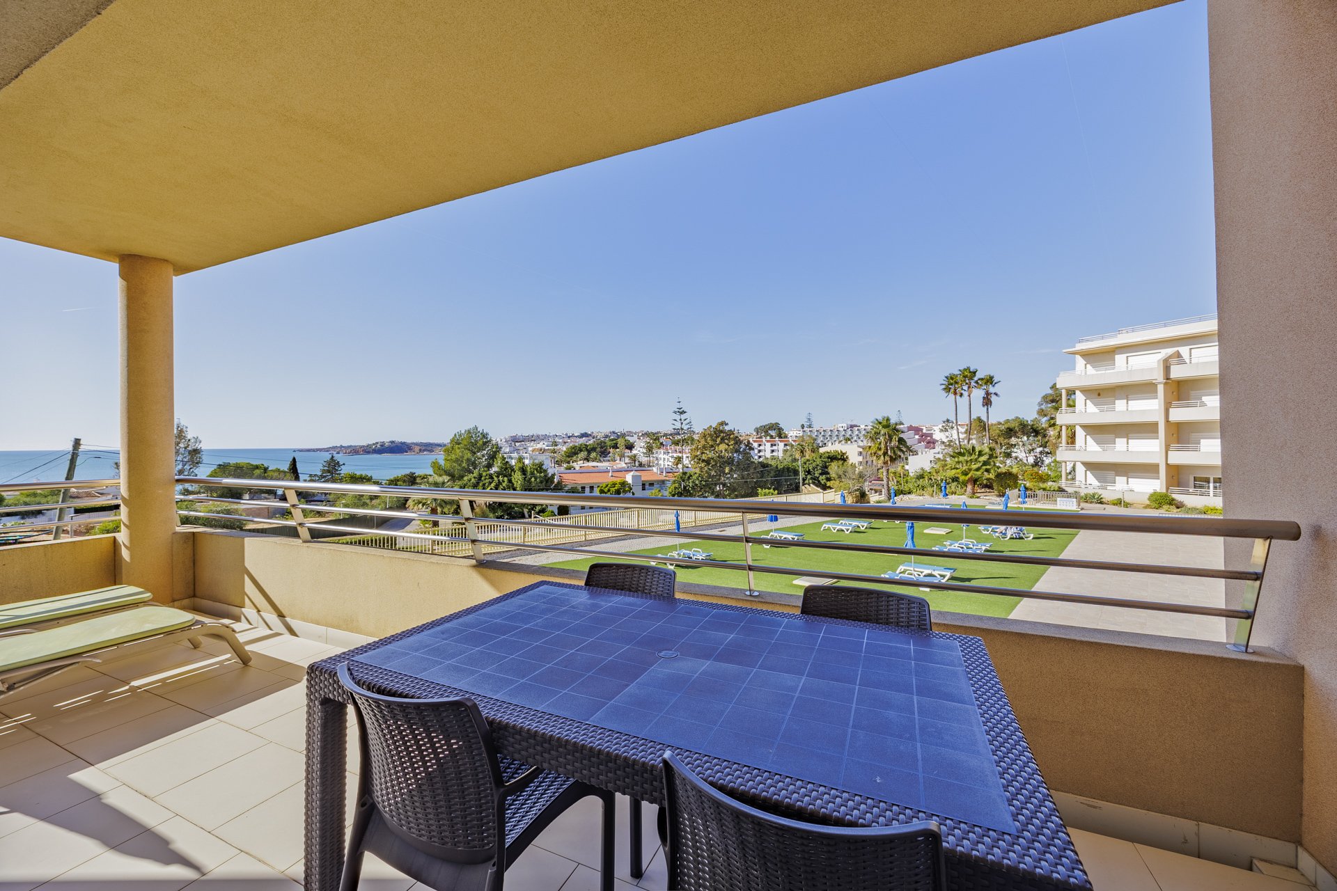Terrace with dining table, sun lounger, and sea view