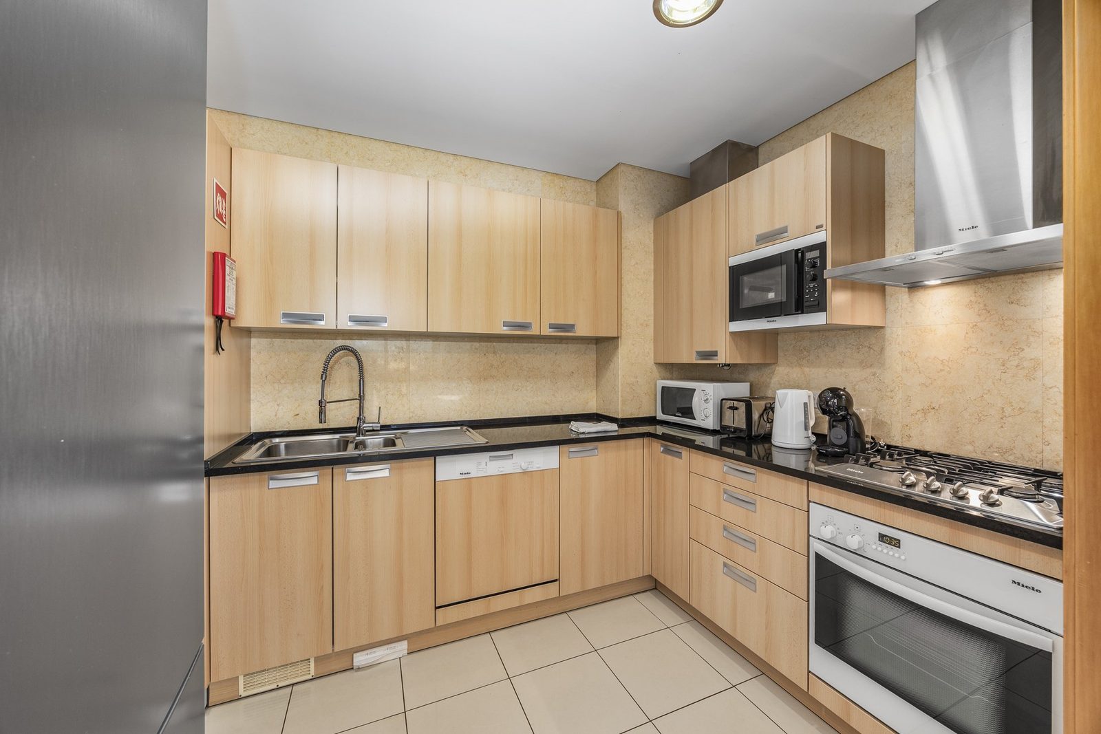 Kitchen with fridge, oven, and hob