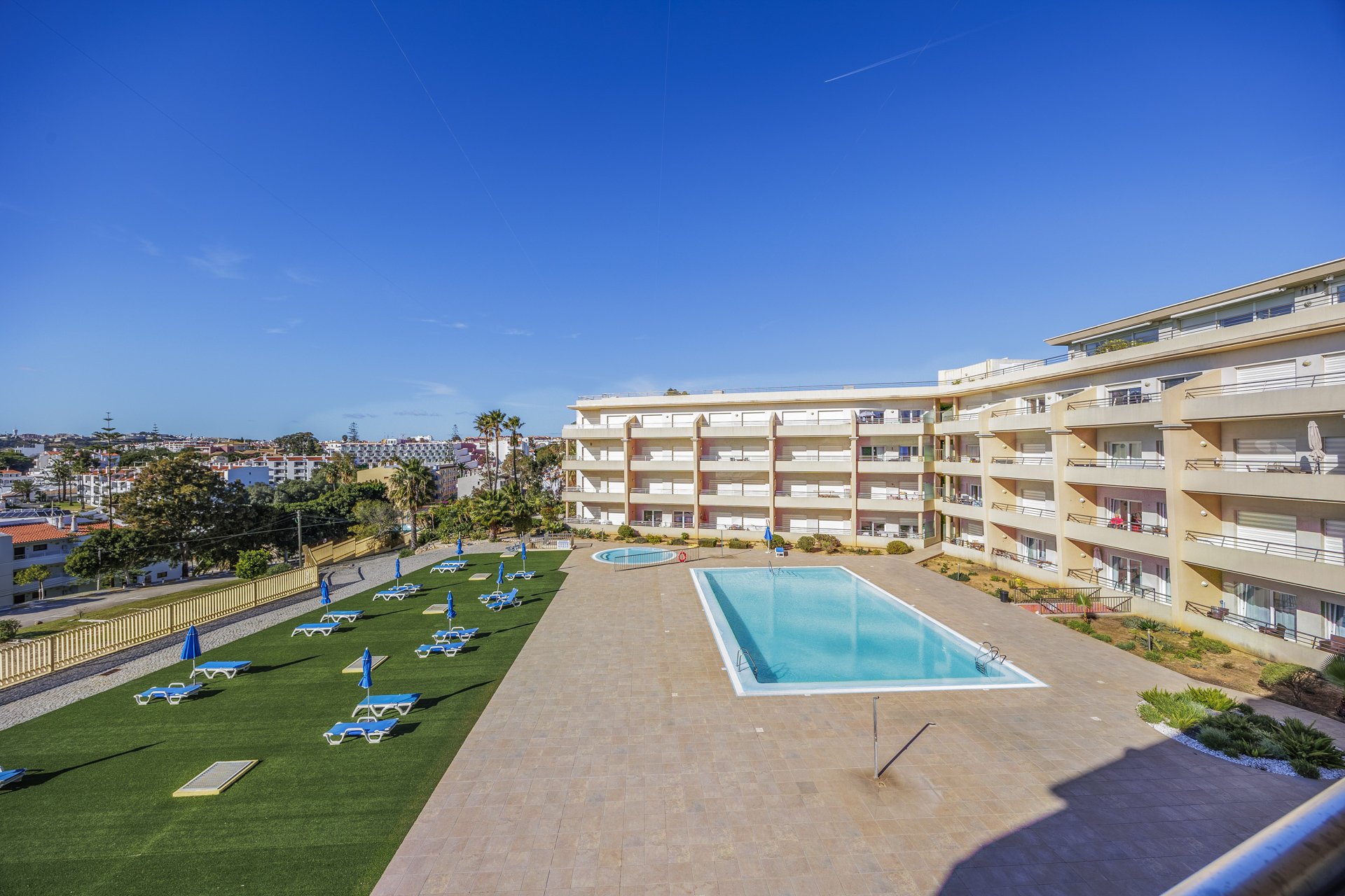 Balcony with wide view over the grounds and pool