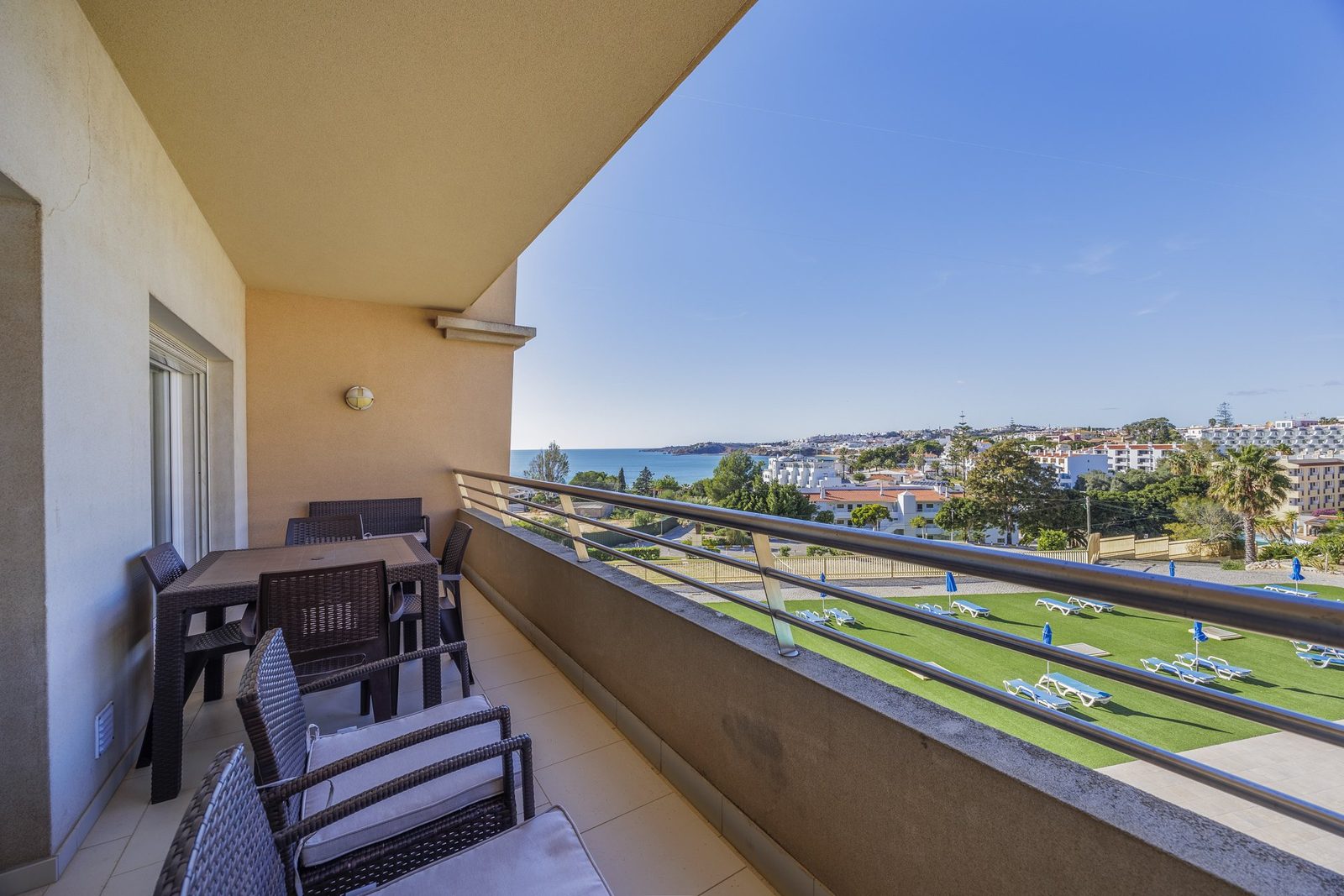 Balcony with dining table, sea and town view