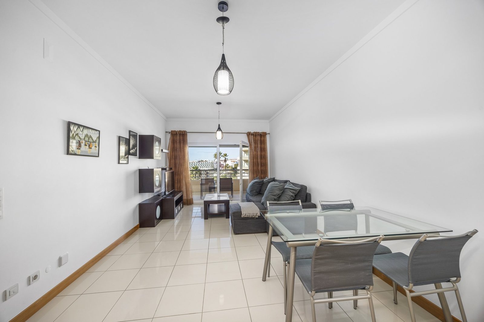 Dining table with sofa and balcony access