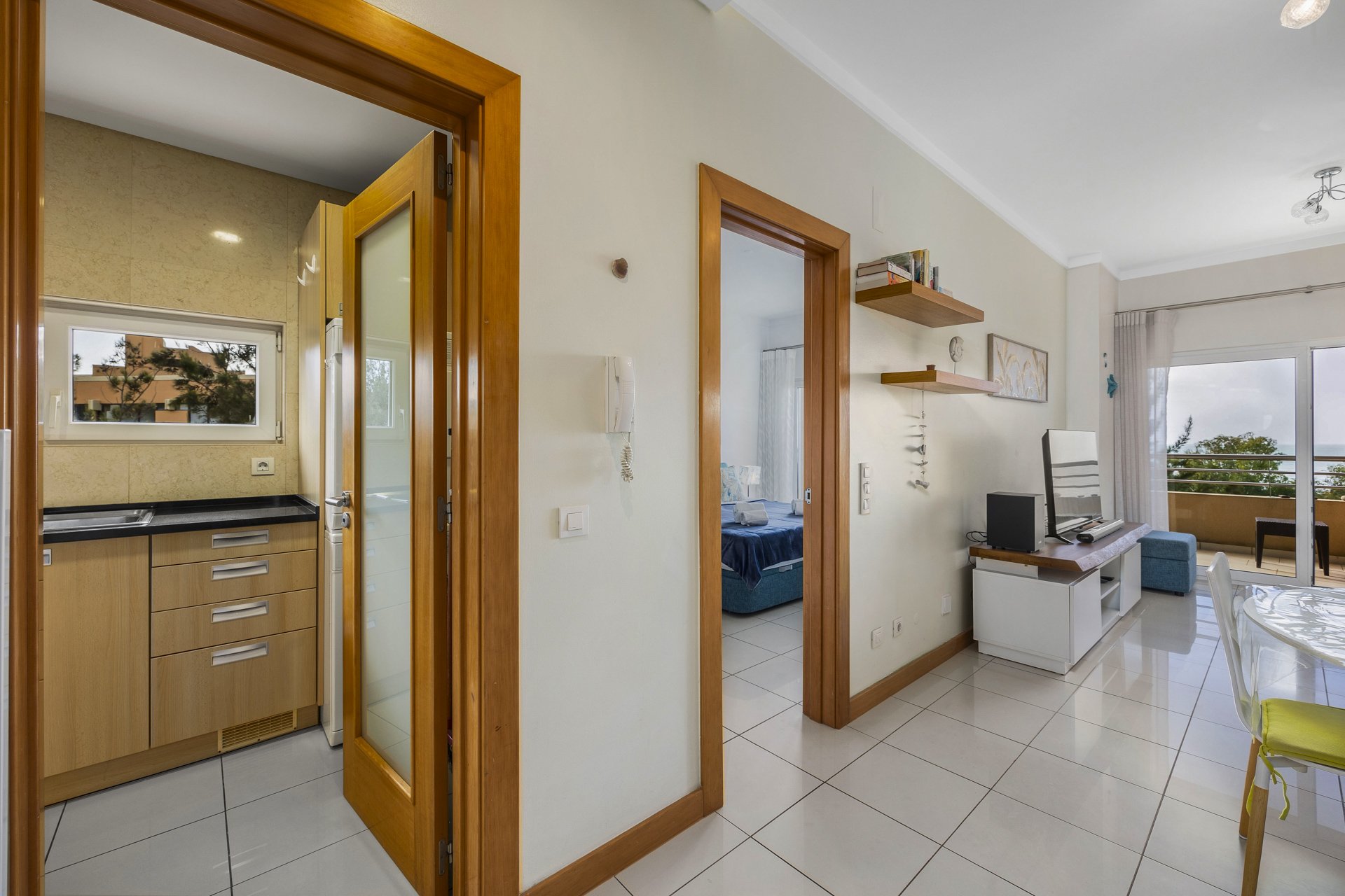 Hallway with kitchen, bedroom, and living area access