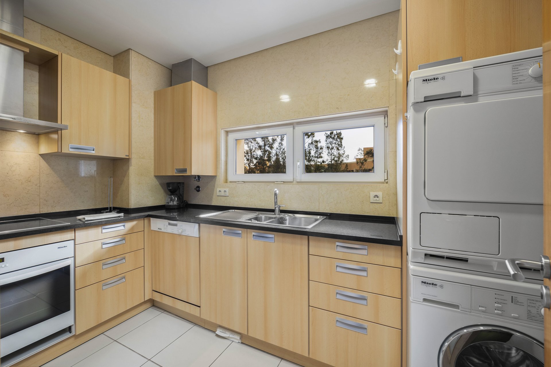 Kitchen with washer-dryer and oven