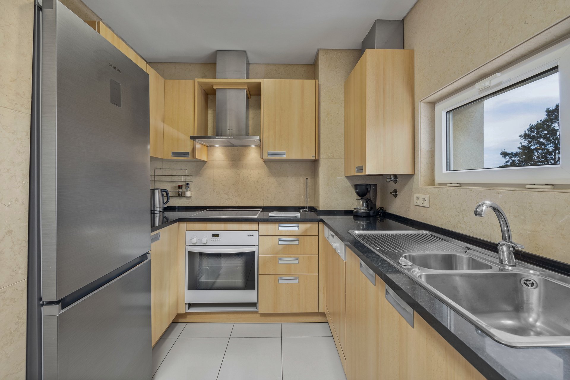 Kitchen with fridge, oven, and sink