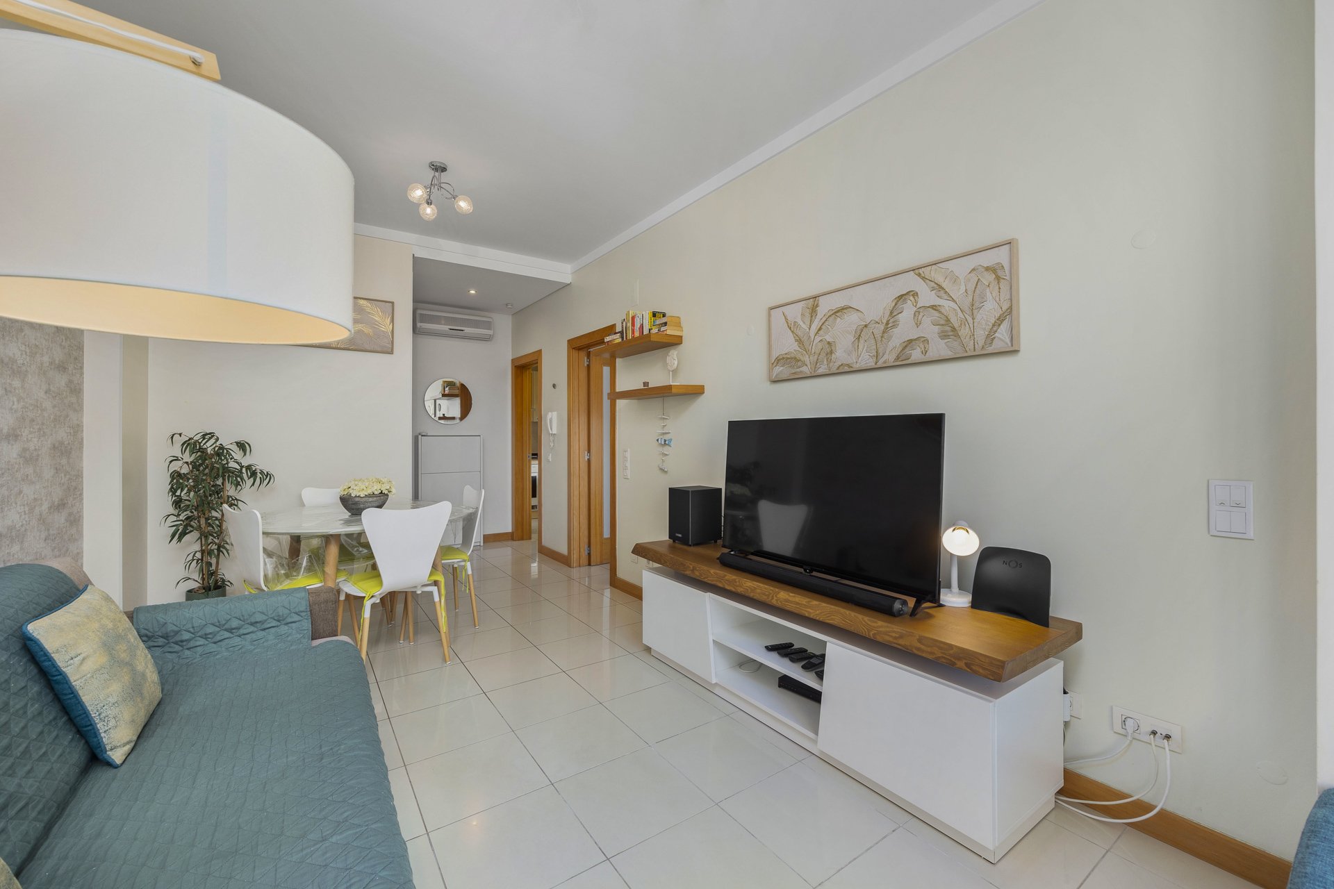Dining table and TV unit with view to the hallway