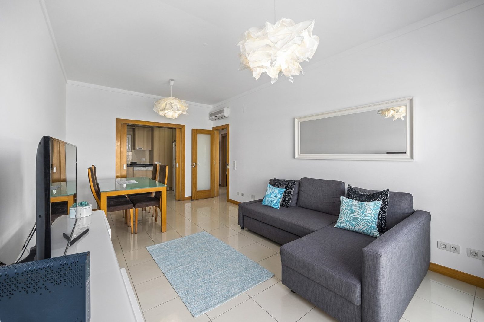 Dining table and TV unit with kitchen view