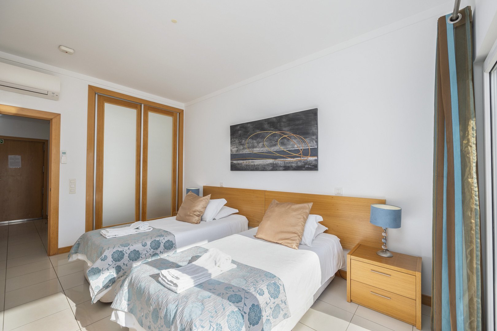 Twin bedroom with wardrobe and hallway access