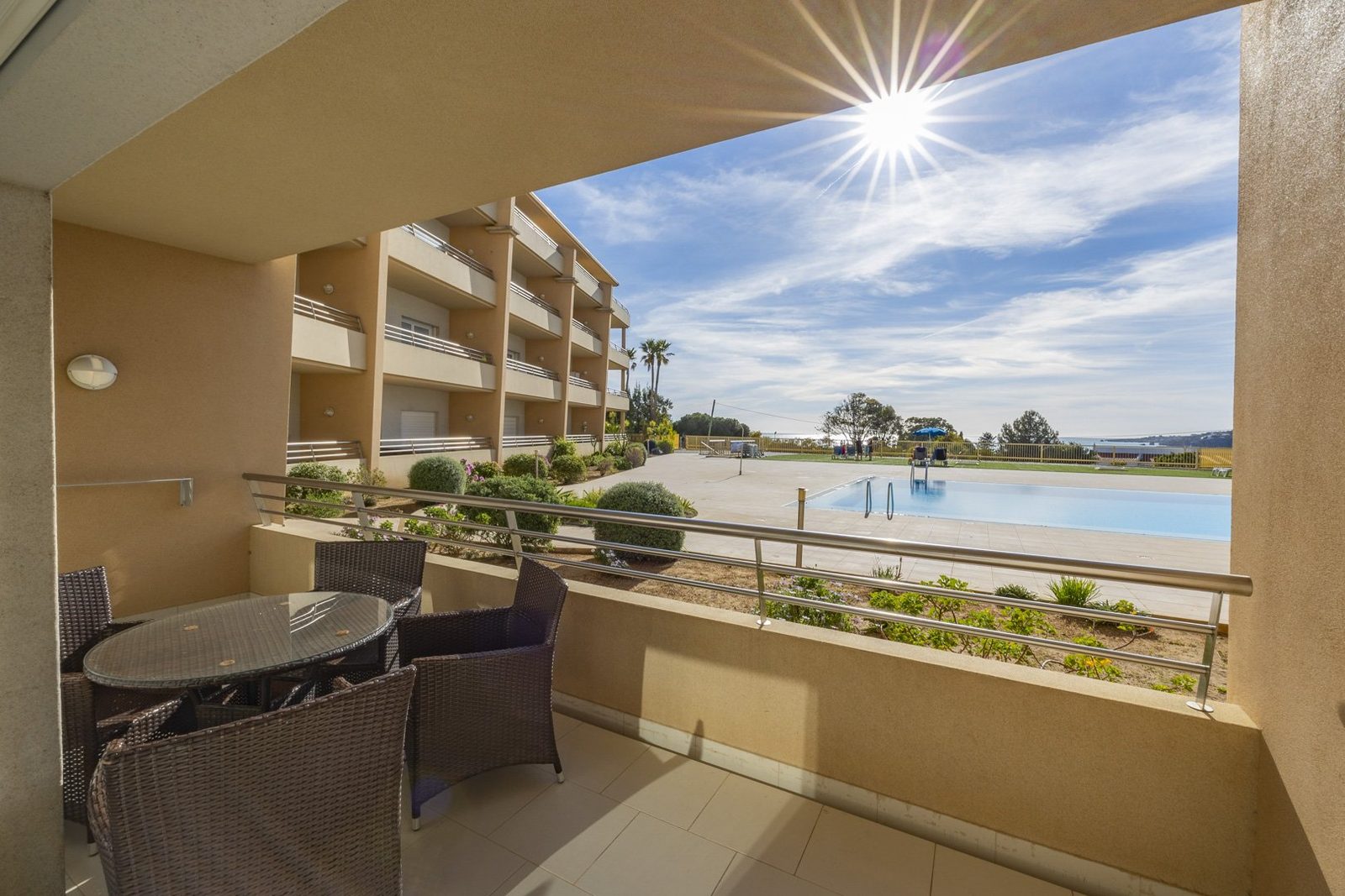 Balcony dining table overlooking the pool and grounds