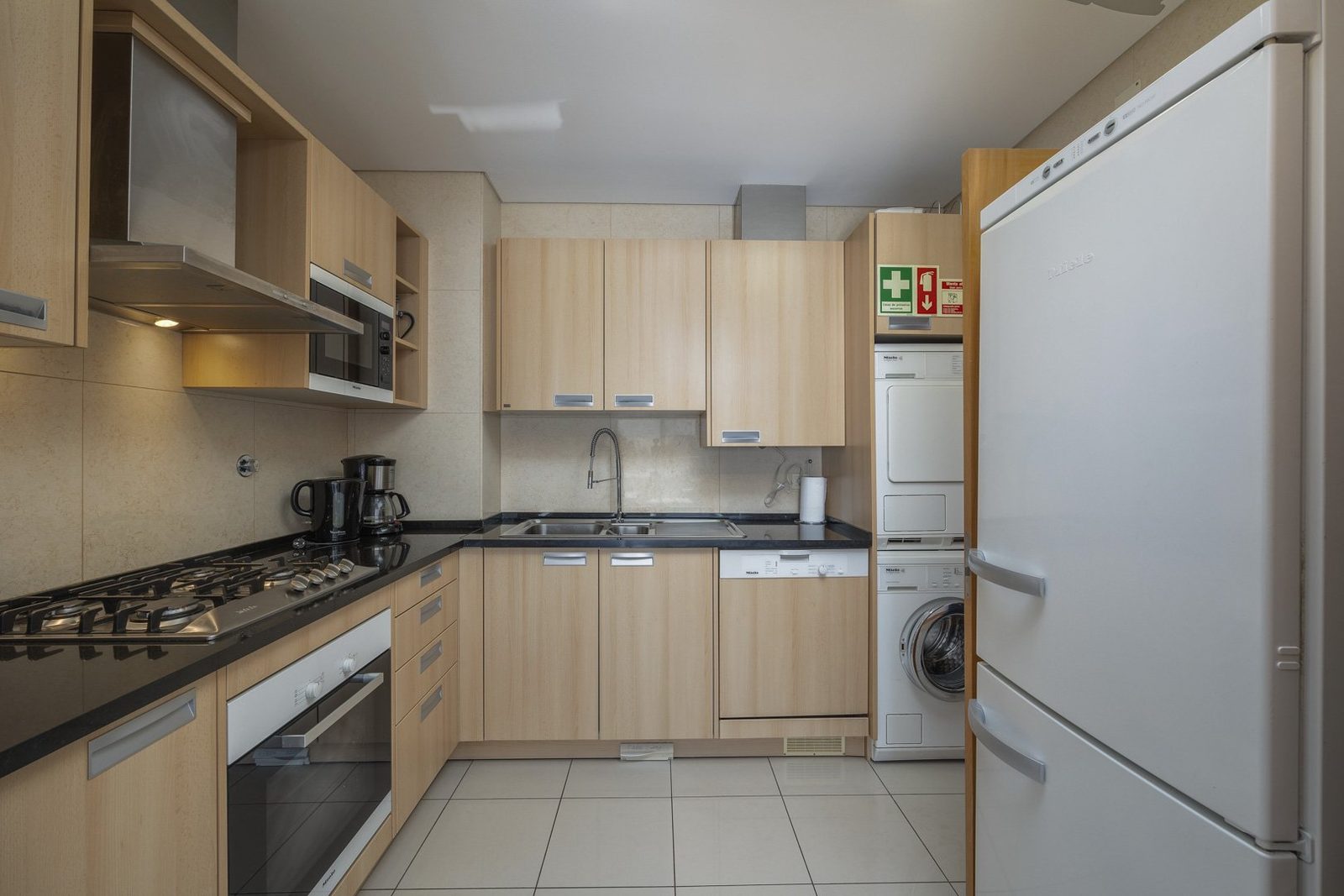 Kitchen with oven, hob, dishwasher, and fridge-freezer