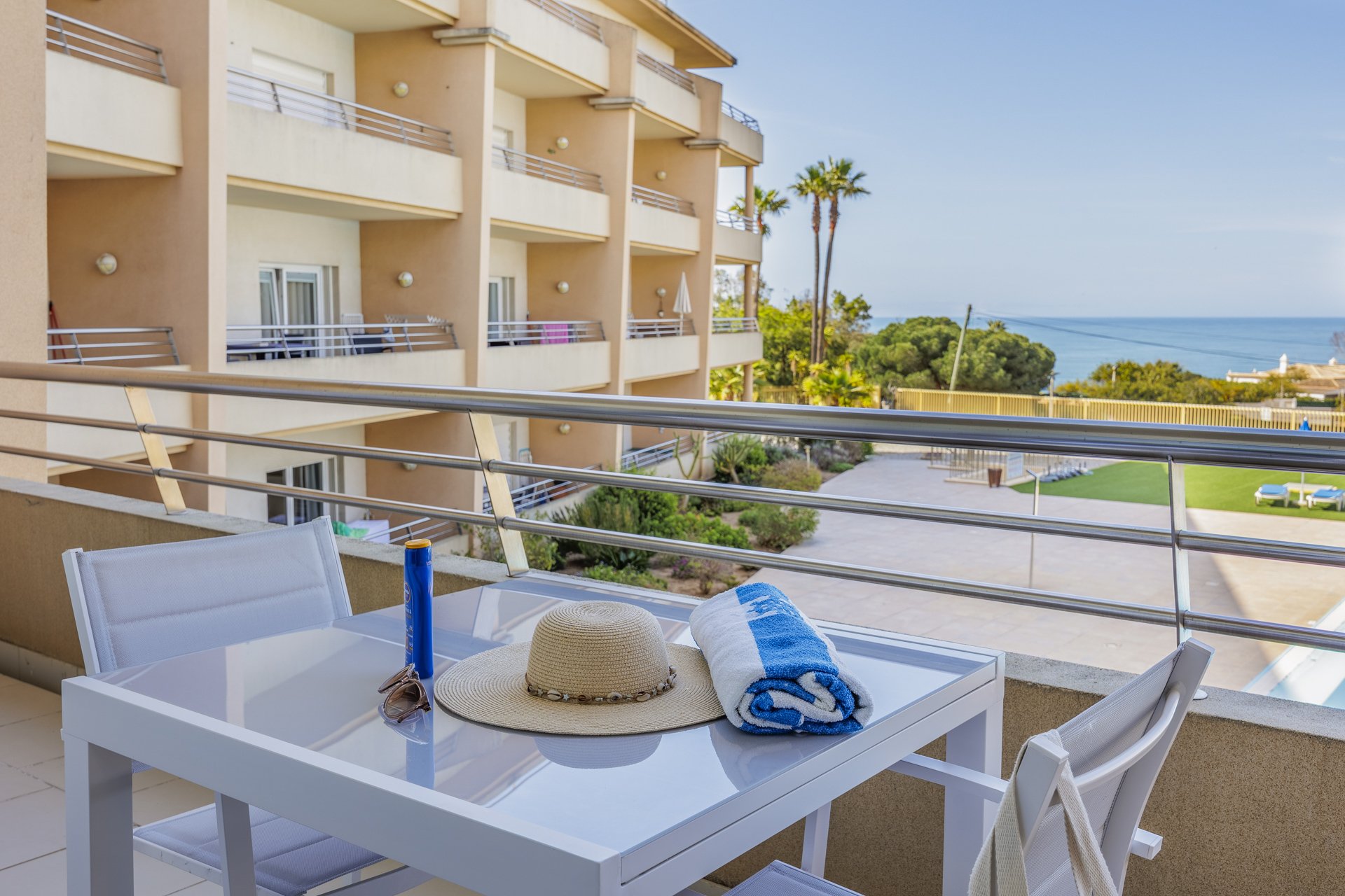 Balcony dining table with sea and building view