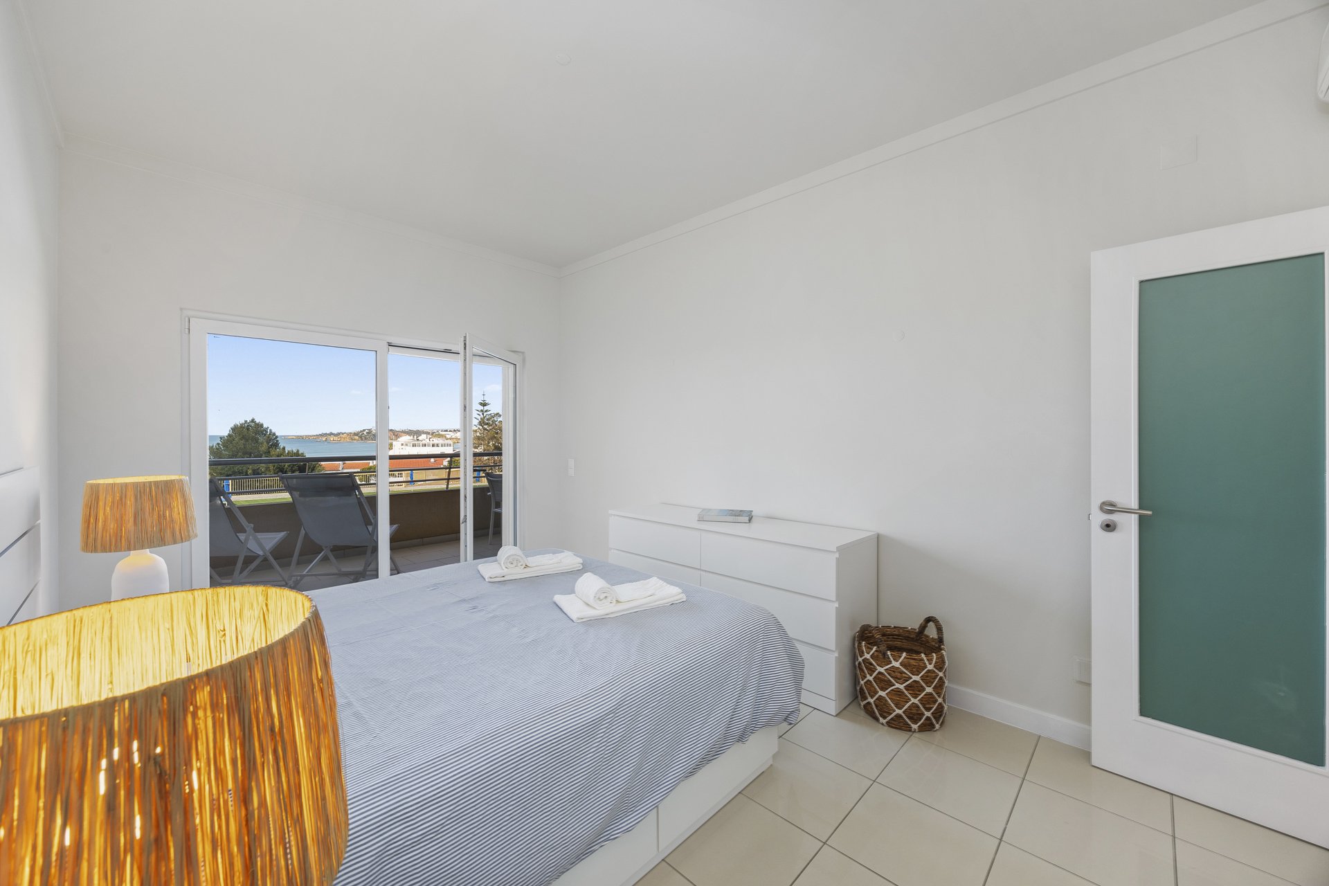 Bedroom with double bed and balcony access, sea view