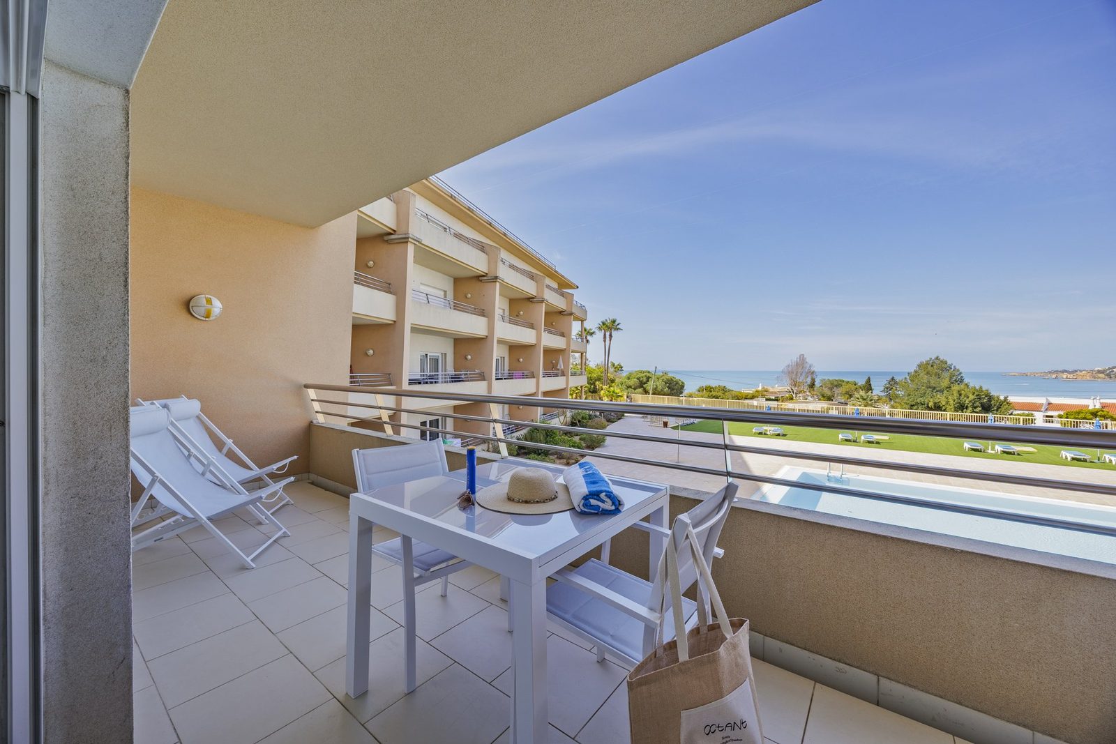 Balcony seating area with sea and building view