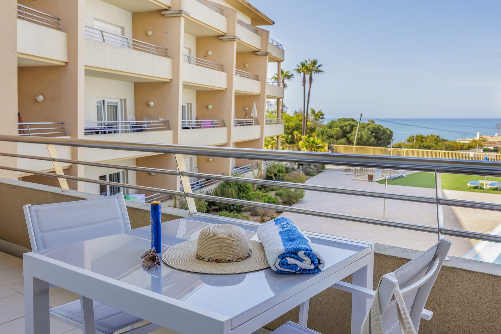 Balcony dining table with sea and building view
